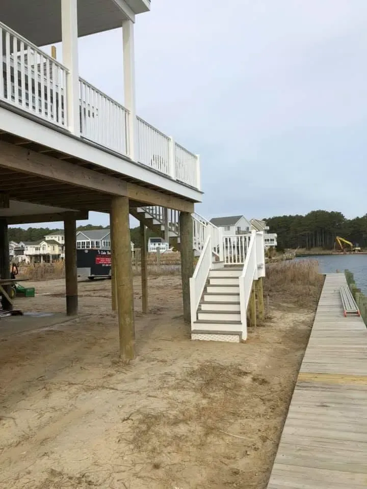 Exterior stairs and new boardwalk beside a raised home