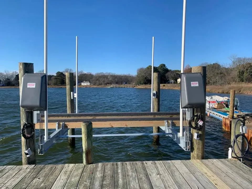 Boat lift installed on pilings at the end of a pier