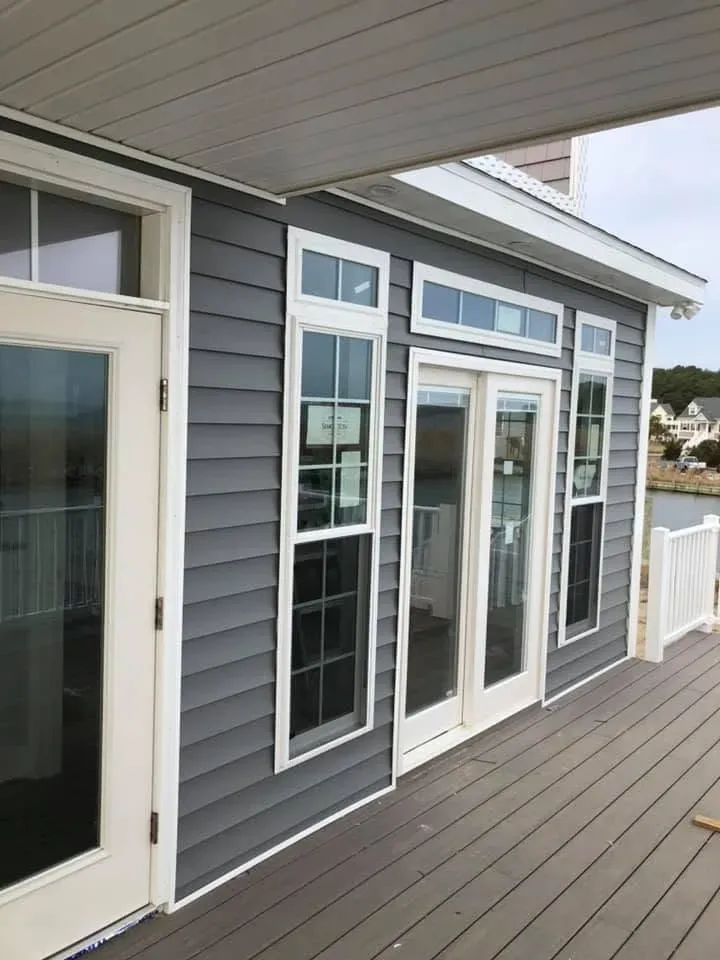 Deck with gray siding and French doors