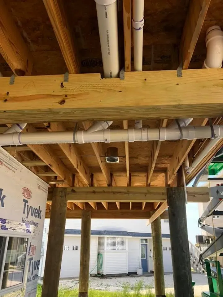 Timber floor framing on driven pilings under a raised coastal home