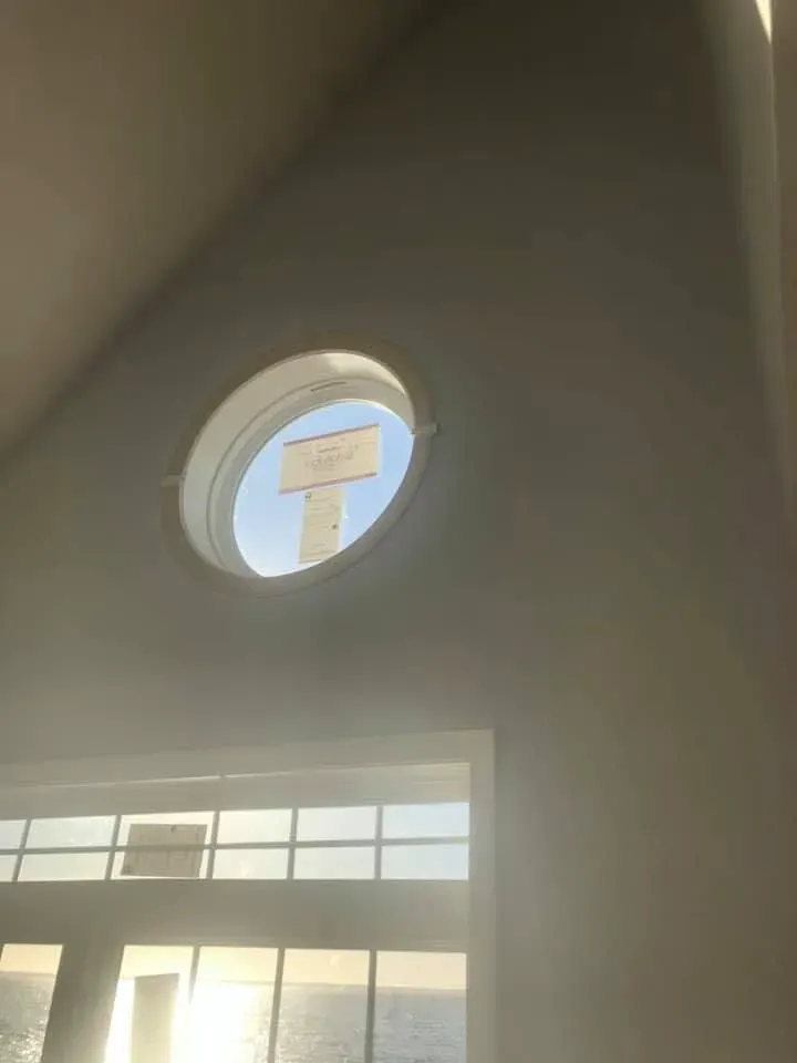 Round accent window in a vaulted wall