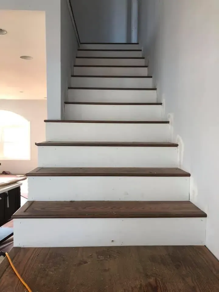White staircase with wood treads